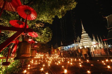 motion blur of people and candle light at wat pan tao temple, chiangmai, thailand.vintage retro concept with film grain.loy krathong festival