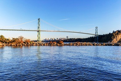 lions gate bridge from west vancouver, canada - with vancouver city center in the background and a jetty in the foreground