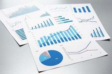 business documents. graphs and charts. documents on gray reflection background.

