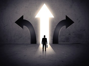 a businessman in doubt, having to choose between three different choices indicated by arrows pointing in opposite direction concept