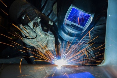 welder industrial automotive part in factory welder at work welding splatter