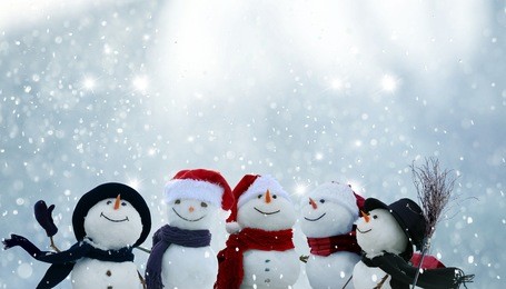 merry christmas and happy new year greeting card with copy-space.many snowmen standing in winter christmas landscape.winter background