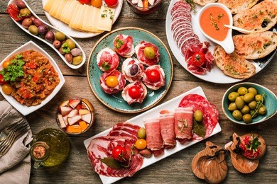 spanish tapas and sangria on wooden table, top view