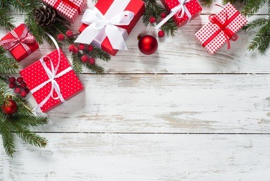 christmas gift box.  christmas presents in red boxes at white wooden table. flat lay with copy space.