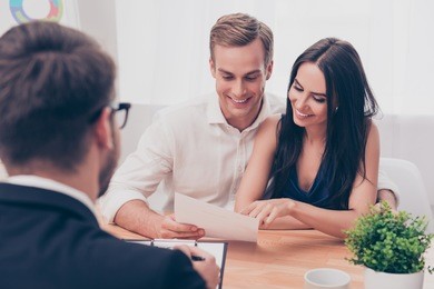 successful lawyer giving consultation to family couple about buying house