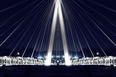 reworked photo of luminous hi-tech suspension bridge / cable-stayed bridge. picturesque evening view of modern city architecture.