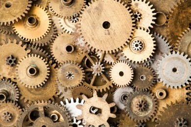 vintage gears macro view. aged mechanical clock wheels background. shallow depth of field, soft focus