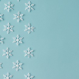 winter pattern made of snowflakes on blue background. winter concept. flat lay.