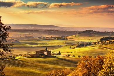 maremma, rural sunrise landscape. countryside farm and green fields. elba island on horizon. tuscany, italy, europe.