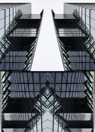double exposure photo of skyscraper fragment in hi-tech / minimalism style with geometric pattern gave this realistic though unreal image. modern architecture. building with glazed aluminum structure.