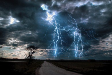 lightning storm over asphalt road