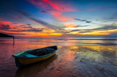 boat with colorful sunset at karon beach phuket , thailand