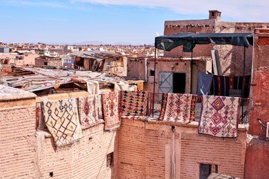 carpets hanging from a roof in the medina marrakech