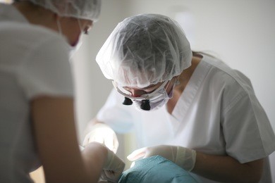 dentist and assistant were bent over by the patient while performing therapeutic manipulation