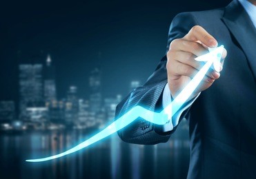 close view of businessman drawing on screen growing graph