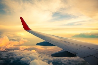 morning sunrise with wing of an airplane. photo applied to tourism operators. picture for add text message or frame website. traveling concept
