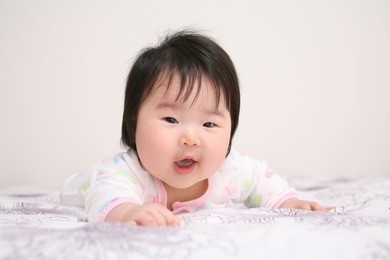 very cute asian baby infant girl reaching and smiling