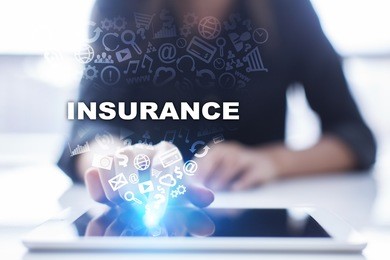 woman is using tablet pc, pressing on virtual screen and selecting insurance.