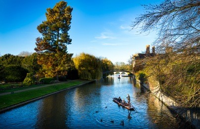 tourists on punt trip (sightseeing with boat) along river cam near kings college in the city of cambridge, united kingdom