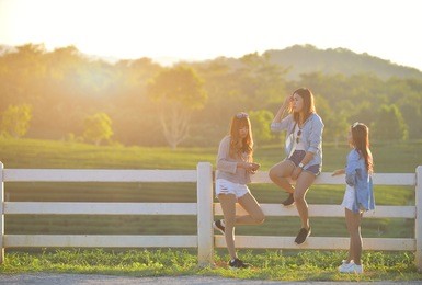 group of young asian girls hanging out in park together,dress in casual and jeans,friendship concept with copy space.