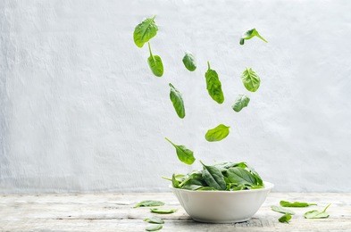 flying spinach on a wood background. tinting. selective focus