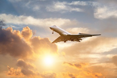 commercial airplane landing at sunrise