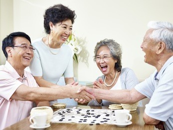 senior asian men shaking hands  at the end of a weiqi game.