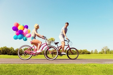 man and woman spending time together and riding bicycles