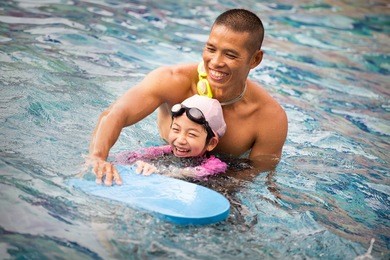 cute little girl learning to swim
