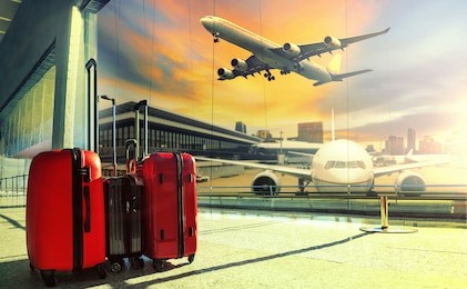 traveling luggage in airport terminal building and jet plane flying over sky