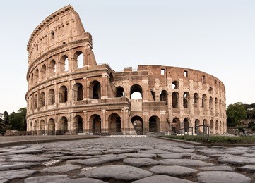 colosseum in rome from ground level along the old roman road during morning hours, bright and light. italy, landmark, colloseum