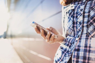 young woman using smart phone outdoors
