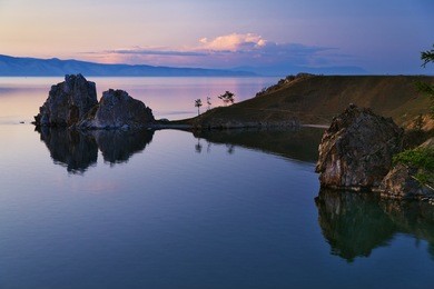 cape burhan and shaman rock on olkhon island of baikal lake at evening, russia