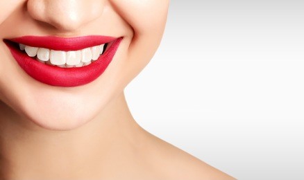 pretty woman smile against a grey background with copyspace