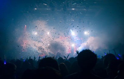 silhouette hands of audience crowd people use smart phones enjoying the club party with concert. celebrate new year party , blurry night club dj party people enjoy of music dancing sound .