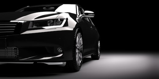 modern new black metallic sedan car in spotlight. generic contemporary desing, brandless. 3d rendering.