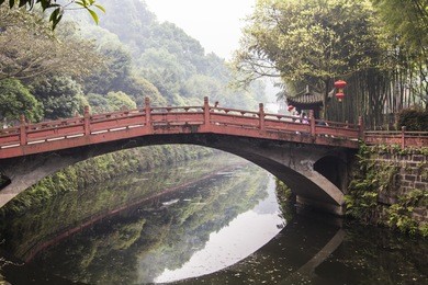 park with chinese bridges and pagodas near leshan buddha statue, leshan, china