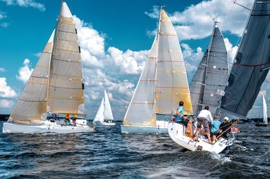 sailing yacht race. team athletes participating in the sailing competition. sailboat. recreational water sports, extreme sport action. healthy active lifestyle. summer fun adventure