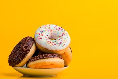 donut. sweet icing sugar food. dessert colorful snack. glazed sprinkles. treat from delicious pastry breakfast. bakery cake. doughnut with frosting. baked unhealthy round.