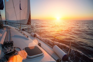 sailing ship yachts in the open sea during fantastic sunset. luxury boats.
