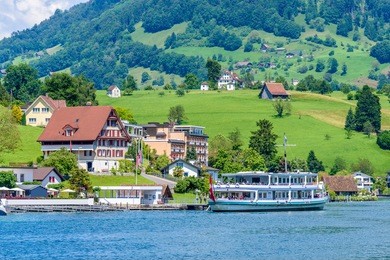 small boat sailing on lucerne lake, switzerland.