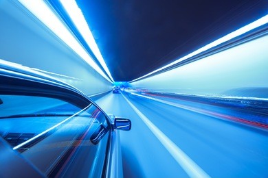 the car moves at fast speed at the night. blured road with lights with car on high speed.