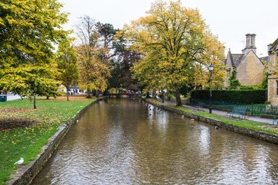 visiting a cute peaceful town of bourton-on-the-water, cotswold, uk in autumn