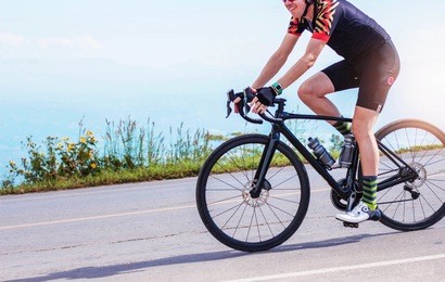 young men were cycling exercise on the road in the morning.