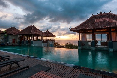 sunset at kuta beach bali from swimming pool view