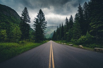 forest road on a cloudy day. glacier national park, montana, usa