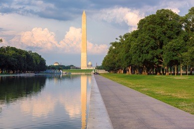 washington monument and reflecting pool at sunset, washington dc, usa.