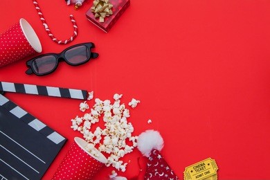 movie tickets, clapperboard, pop corn and 3d glasses in a red frame background..flat lay .christmas concept