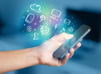 hand holding smartphone with glowing multimedia icons 