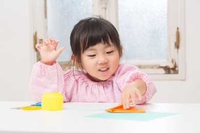 cute asian girl playing with origami